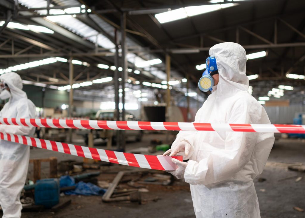 Technicians putting up hazard tape