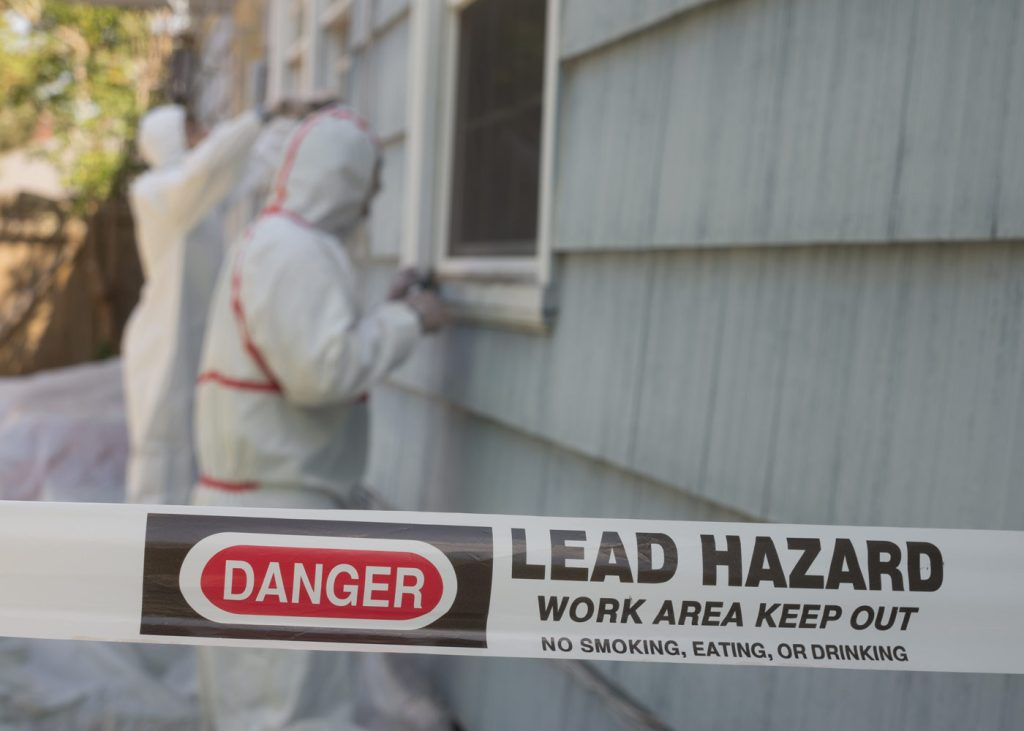 Lead hazard caution tape to secure a worksite as technicians conduct work