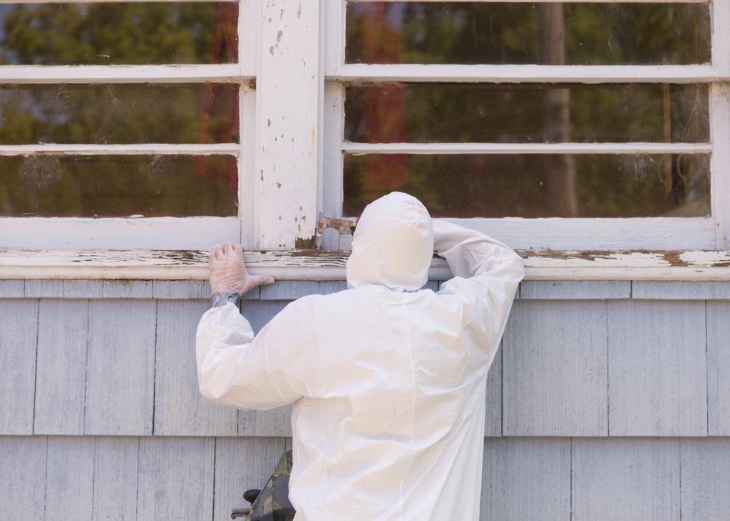 Technician in safety gear working on lead abatement