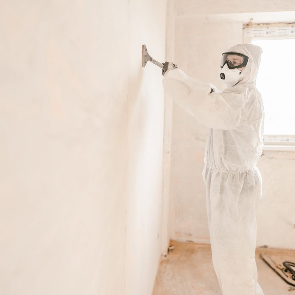 Technicians in safety gear working on lead paint removal