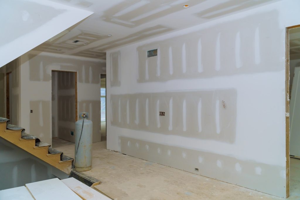 Drywall may contain asbestos if your house was built earlier than 2000.